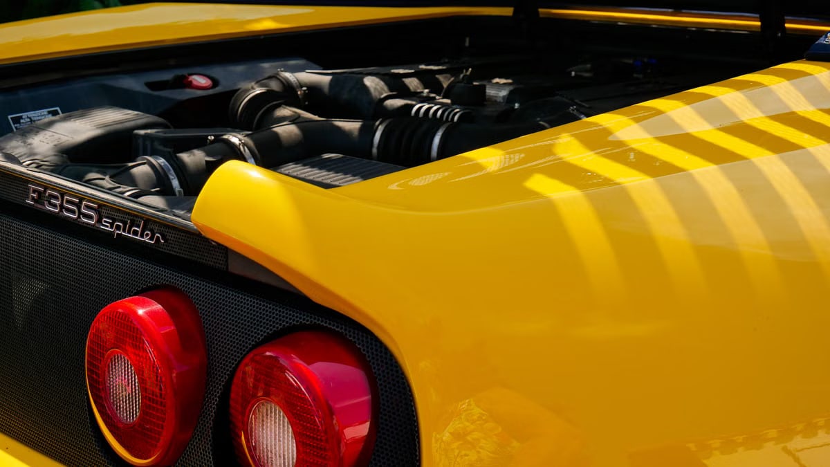 Detailed view of a yellow Ferrari F355 Spider at Noirmoutier-en-l'Île, ideal for automobile enthusiasts.